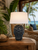 Deep blue sea anemone ceramic table lamp displayed in a tropical coastal room with warm natural textures