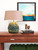 Earth tone sea anemone ceramic lamp displayed on a wood console in a refined coastal room
