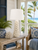 White coral ceramic table lamp displayed beside a window in a bright upscale coastal living room
