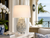 Handmade Thai blue and white sea anemone ceramic table lamp styled beside a window in a light-filled room