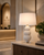 Handmade Thai white sea urchin ceramic table lamp displayed in an upscale hotel lobby interior