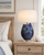 Handmade Thai blue ceramic crab table lamp displayed in a beach house bedroom setting