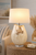 Handmade Thai white ceramic crab table lamp displayed on a side table in a light coastal interior
