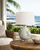 Handmade Thai cream and indigo blue ceramic sea turtle table lamp displayed on a coastal lanai by the sea