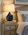 Handmade Thai deep blue ceramic crab table lamp displayed on a nightstand in a coastal bedroom