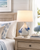 Handmade Thai blue and white ceramic sea crab table lamp displayed on a nightstand in a coastal bedroom