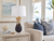 Handmade Thai blue pineapple ceramic table lamp styled beside seating in a Florida beach house interior.