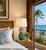 Blue and white pineapple ceramic table lamp displayed in an upscale Hawaiian resort bedroom with tropical coastal decor