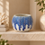 Handmade Thai blue and white sea urchin ceramic vase displayed without flowers on an elegant stone wall shelf
