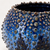 Close-up detail of the ocean blue glaze and raised sea urchin texture on a handmade Thai ceramic vase