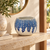 Handmade Thai blue and white sea urchin vase displayed on a warm stone console without flowers