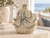 Cream and soft blue octopus ceramic vase displayed on a stone table in an elegant coastal room