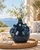 Handmade Thai sea turtle ceramic vase styled without flowers in a Mediterranean coastal setting