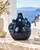 Deep ocean blue sea turtle ceramic vase displayed without flowers in a warm coastal interior