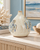 Handmade Thai sea turtle ceramic vase displayed without flowers in a warm coastal setting