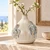Thai sea turtle ceramic vase styled with delicate botanical branches in a coastal interior