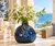 Small handmade sea turtle ceramic vase with ocean blue glaze displayed in a bright coastal setting