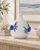 Handmade Thai sea crab ceramic vase displayed without flowers in a bright coastal interior