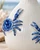 Close-up of sculpted ocean blue crab details and textured white glaze on Thai ceramic vase