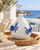 White and blue sea crab ceramic vase displayed without flowers in a coastal interior