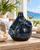 Handmade Thai sea crab ceramic vase displayed without flowers on a tropical lanai