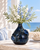 Deep blue sea crab ceramic vase styled with delicate flowers on an elegant coastal veranda