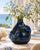Deep ocean blue sea crab ceramic vase styled with delicate white and blue flowers in a coastal interior