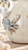 Close-up of sculpted sea crab details and textured cream reactive glaze on Thai ceramic vase