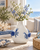 White and blue sea crab ceramic vase styled with delicate flowers in a coastal interior
