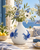 Handmade Thai sea crab vase styled with flowers in a bright coastal veranda setting