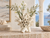 Handcrafted ivory-white ceramic Ocean Bloom vase styled on a travertine console in a bright coastal interior