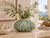 Green Moss handmade Thai ceramic vase styled with delicate white flowers in a warm coastal interior
