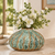 Green Moss textured ceramic vase styled with delicate white flowers in a warm organic interior