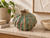 Small Green Moss textured ceramic vase styled on a stone console with natural decor