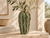 Green Moss ceramic cactus vase styled with delicate flowers in a warm Mediterranean-inspired interior
