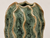 Close-up of Green Moss ceramic vase showing sculptural ridges, speckled glaze, and textured surface