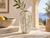 Handmade Thai textured ceramic vase displayed in a sunlit Mediterranean coastal interior