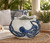 Close-up of cobalt-blue octopus tentacles, raised suction cups, and textured white glaze on a handmade Thai ceramic bowl.