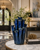 Royal blue ceramic coral vase displayed on a table in a luxury hotel lobby interior