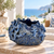 Deep ocean blue sea life ceramic vase displayed without flowers on a coastal lanai