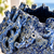 Close-up of sculpted coral and sea life details on deep ocean blue Thai ceramic vase