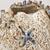 Close-up of sculpted starfish and coral-inspired details on cream Thai ceramic vase