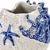 Close-up of sculpted starfish coral details and cobalt blue glaze on Thai ceramic vase