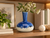 Handmade Thai blue and white ceramic vase styled on a shelf with books and greenery
