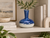 Handmade blue and white ceramic vase displayed on an elegant shelf with neutral decor