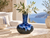 Ocean blue Thai ceramic vase styled with delicate white flowers in an elegant coastal Mediterranean interior