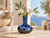 Ocean blue reactive glaze ceramic vase styled in a sunlit coastal interior with natural decorative accents