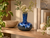 Handmade Thai ocean blue ceramic vase styled on a shelf with books and greenery