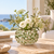 Green and white coral ceramic vase with white flowers styled in a bright coastal interior
