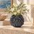 Handmade Thai blue barnacle vase with flowers in a Mediterranean coastal setting
